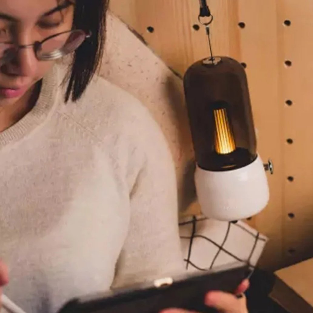 Portable vintage lamp hanging next to a reading chair