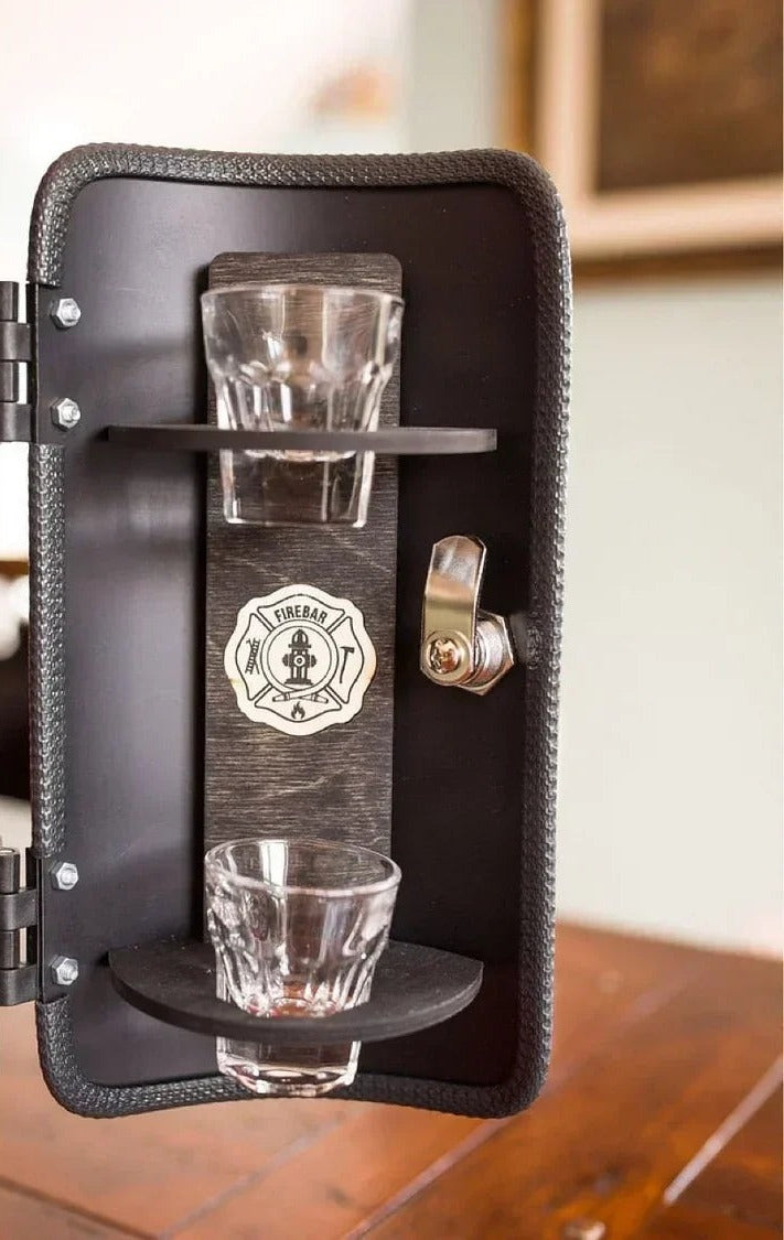 Inside door of the fire extinguisher mini bar with shot glasses