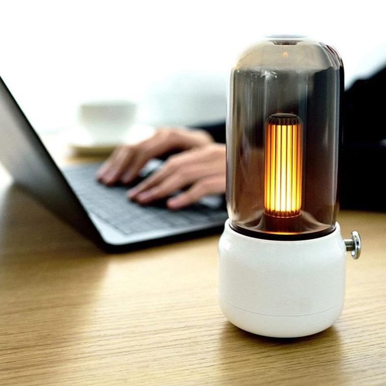 Vintage table lamp on a desk next to a laptop